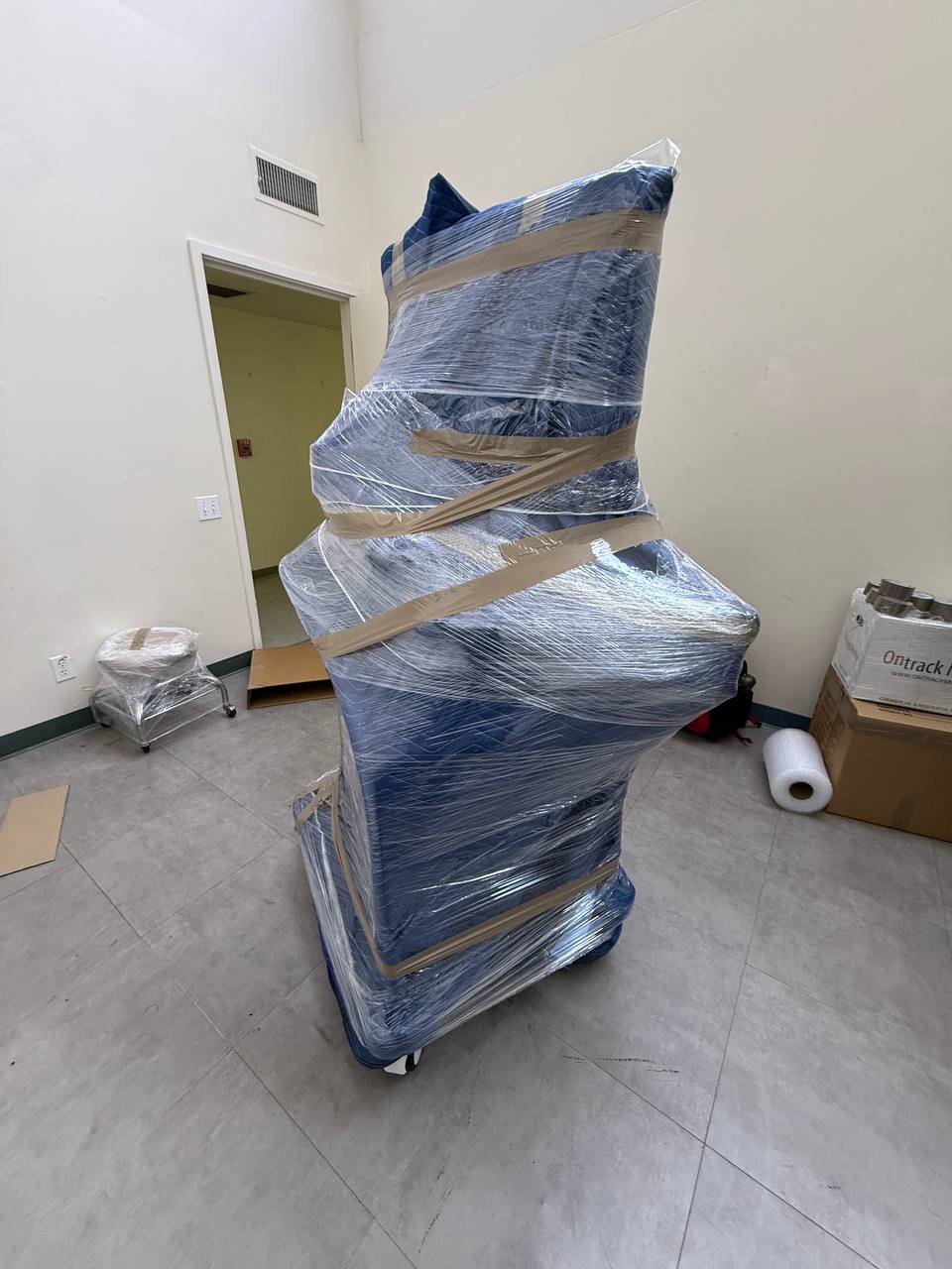 Furniture wrapped with moving blankets